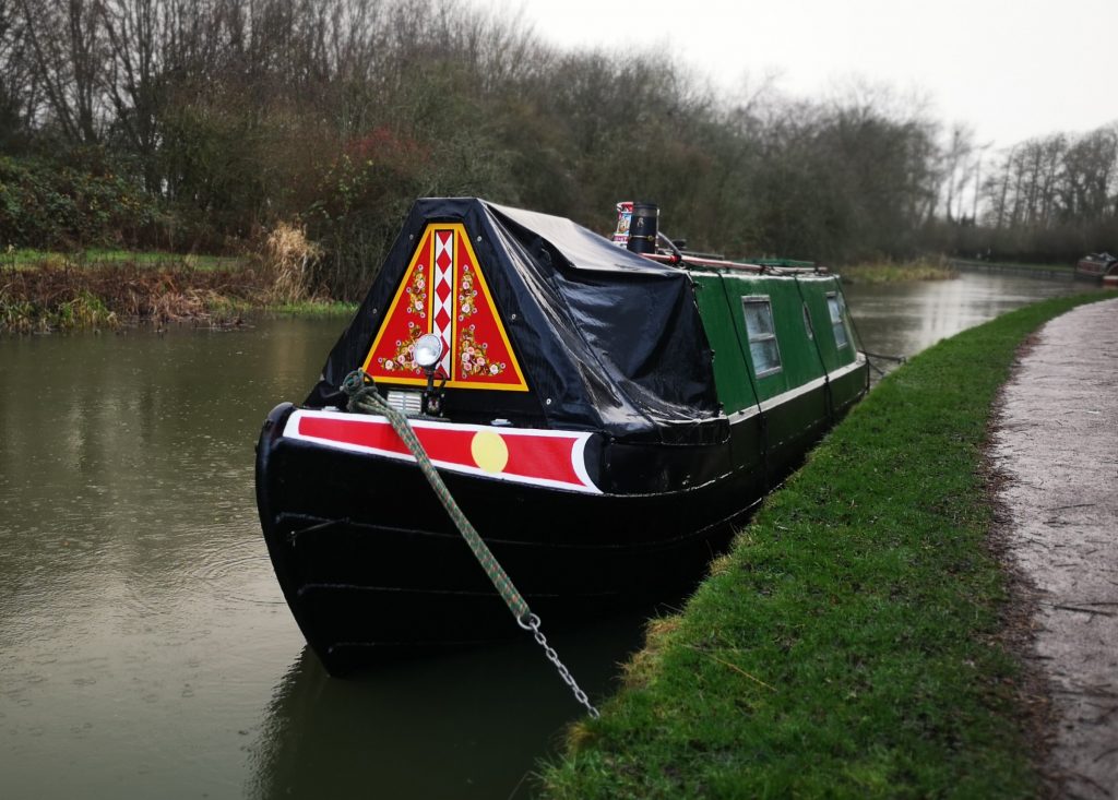 narrowboat with cratchboard on display 