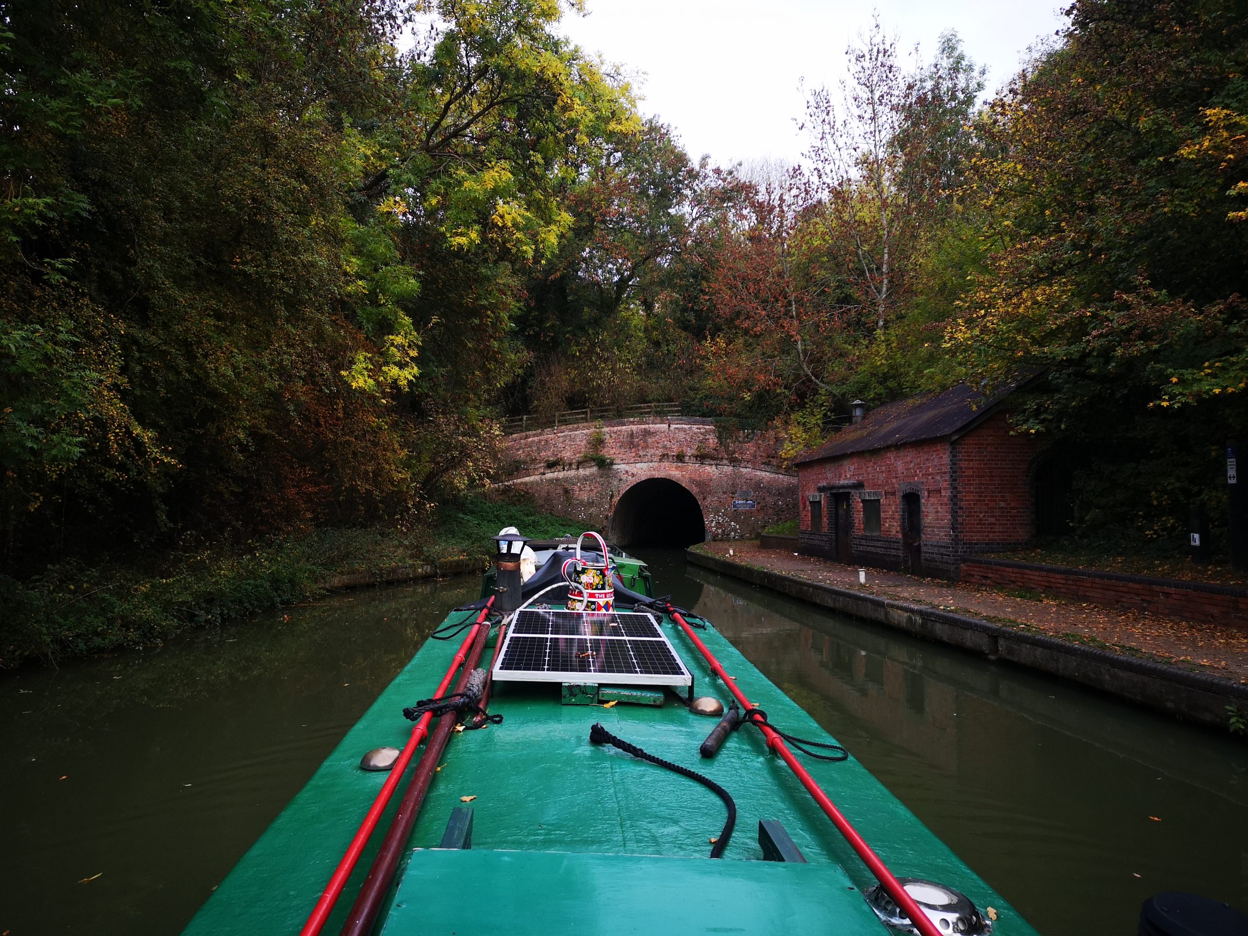 two narrowboats heading into blisworth tunnel from stoke bruerne